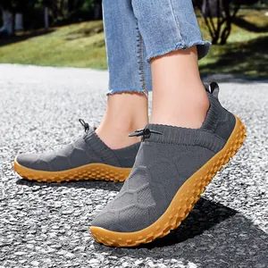 Grey breathable knit slip-on sneakers with gum rubber soles for outdoor hiking trips