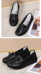 Detailweergave van zwarte lederen verpleegsters loafers met strikje en textuur