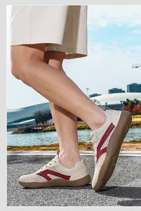 Detail view of men's breathable mesh sneakers with wide toe design in outdoor setting