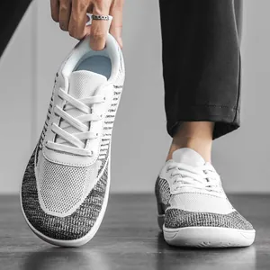 Detailed view of breathable grey and white knit barefoot shoes with a wide toe box design