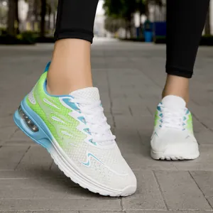 Close-up of women's white fly-knit running shoes with lime green accents and air cushion