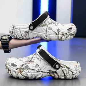 Herren-Clogs mit Tarnmuster, dicker Sohle und verstellbarem Riemen für zwei Tragearten.
