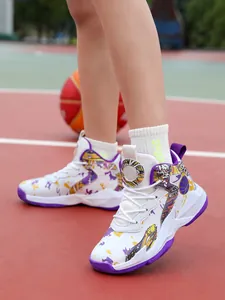 Detail view of children's basketball shoes with purple graffiti on a basketball court.