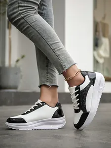 Detail view of stylish women's black and white sequined casual sneakers for spring