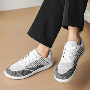 Detailed view of breathable wide-toe barefoot sneakers featuring fly-knit mesh upper