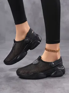 Close-up detail view of women's black breathable fly-knit platform mules with mesh upper