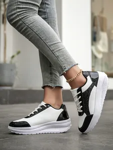 Close-up of black and white color-blocked sneakers with sequins and platform sole