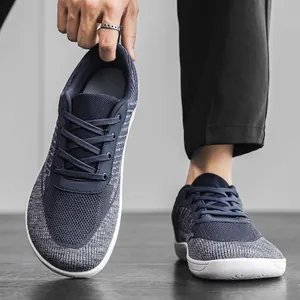 Detail view of breathable grey flyknit barefoot shoes with a wide toe box design.