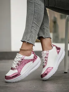 Fashionable white women's sneakers with pink glitter and metallic panels on feet