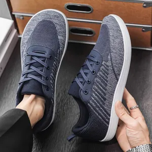 Detailed view of breathable blue fly-knit barefoot shoes with a wide toe box design.