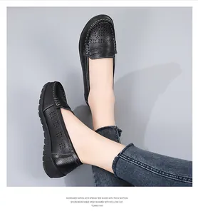 Detailed macro view of black hollow-out leather loafers for women with thick beef tendon sole