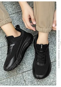 Detailed view of black wide-toe running shoes with breathable mesh and thick soles