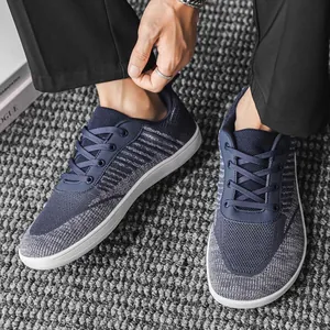 Close-up view of breathable navy blue knit barefoot sneakers for men and women
