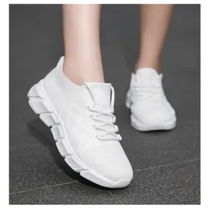 Detailed side view of stylish white sneakers with platform soles and mesh fabric