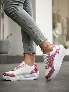 Detail shot of fashionable white platform sneakers with pink glitter and metallic accents