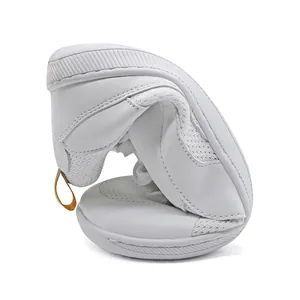 Close-up of flexible white retro sneakers demonstrating the soft and bendable sole
