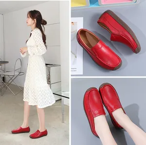 Close-up of red leather flat loafers with breathable hollow design for women's casual wear.