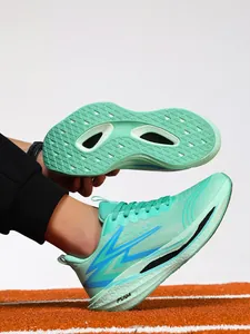 Detailed macro view of mint green carbon plate running shoe showing the textured non-slip sole