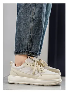 Detailed side view of beige wide-toe breathable sneakers worn with denim jeans.