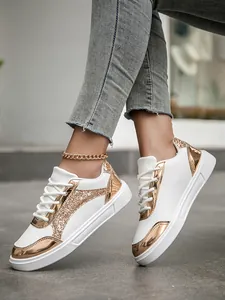 On-foot view of women's white sneakers with rose gold metallic and glitter accents.