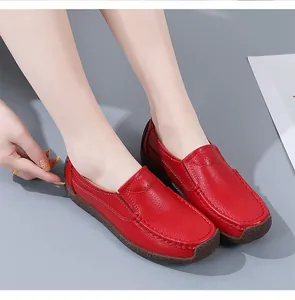 Detail shot of red genuine leather loafers for women showing the soft grain texture finish.