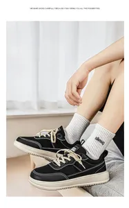 Macro view of black wide-toe casual sneakers on model in a modern indoor setting