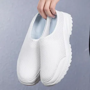 Close-up detail of lightweight white mesh slip-on walking shoes with flexible soft sole
