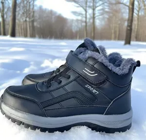 Close-up of black fur-lined winter snow boots for men and women on outdoor snow.