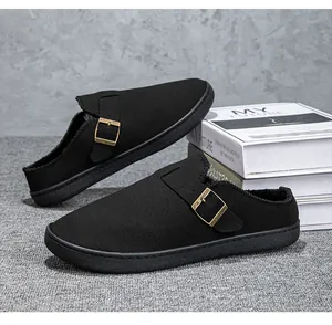Black fleece-lined clogs with metal buckle detail and cozy interior.