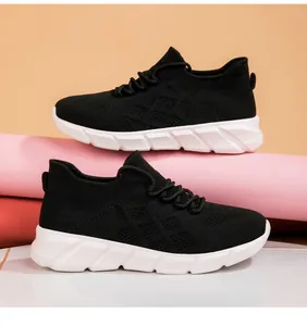 Close-up of black knitted breathable casual sneakers with thick white platform soles