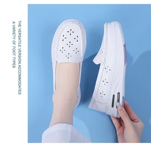 Detail view of breathable white nursing shoes with hollowed flower pattern and air cushion