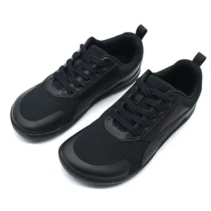 Top-down view of black minimalist barefoot sneakers with breathable mesh and wide toe box