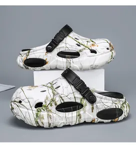Detailed side view of white camouflage clogs with black adjustable straps and thick soles