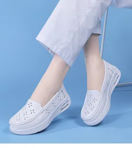 Side view detail of white breathable air cushion nurse shoes with decorative hollow out pattern