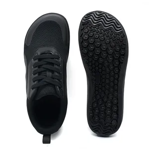 High-quality detail view showing top mesh and non-slip sole of black barefoot sneakers