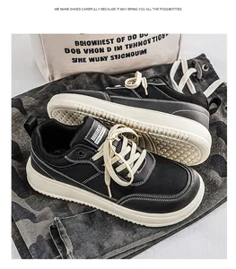 Close-up view of black breathable wide-toe sneakers featuring thick white soles and cream laces.
