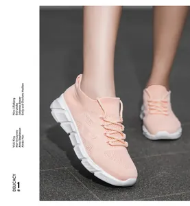 Close-up of pink breathable knit sneakers with a white platform sole for women