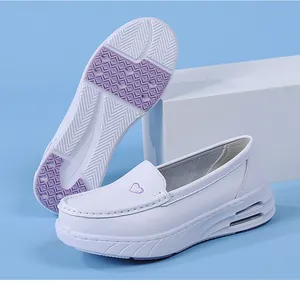 Detailed view of white air-cushion nurse shoe and non-slip purple sole pattern