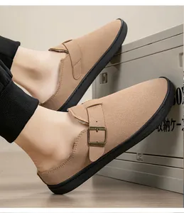Detailed view of fleece-lined suede slippers with vintage bronze metal buckle