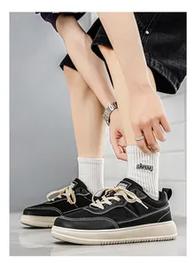 Detailed side view of black unisex wide-toe casual sneakers with thick white soles.