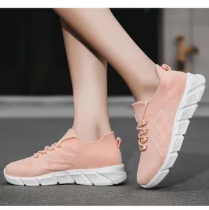 Close-up detail of breathable pink knit platform sneakers for women worn by a model.