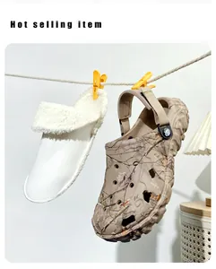 Detailed view of camouflage clogs hanging with a detachable soft white fleece liner