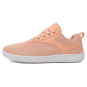 Close-up of breathable peach pink fly-knit barefoot sneaker with flexible white sole