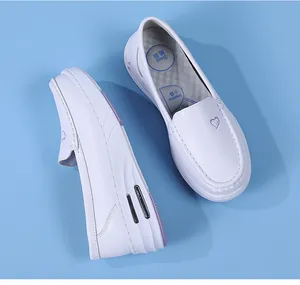 Close-up detail of white medical nurse shoes featuring air cushion and thick platform sole
