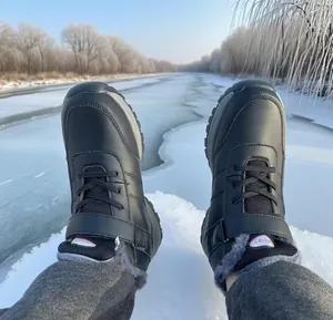 POV perspective of black waterproof snow boots with warm faux fur lining on icy river bank