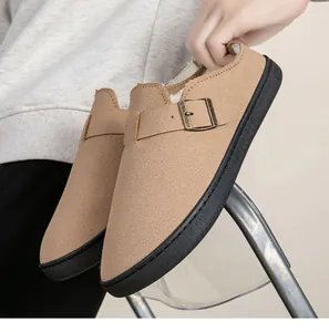Close-up of warm tan suede Birkenstock-style slippers with fleece lining and metal buckle