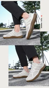 Detalle de las zapatillas de senderismo blancas para hombre con punta ancha en asfalto