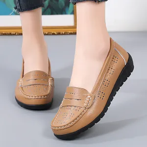 Casual women's tan leather loafers with intricate hollow-out floral pattern and flat soft soles