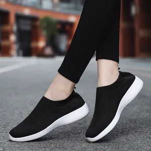 Lightweight black slip-on sneakers for women with breathable knit upper and white sole.