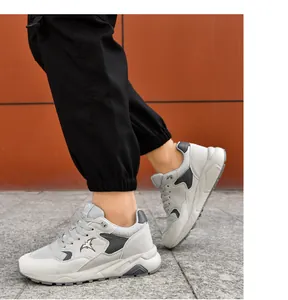 Detailed side view of grey lightweight men's casual running shoes with bird logo